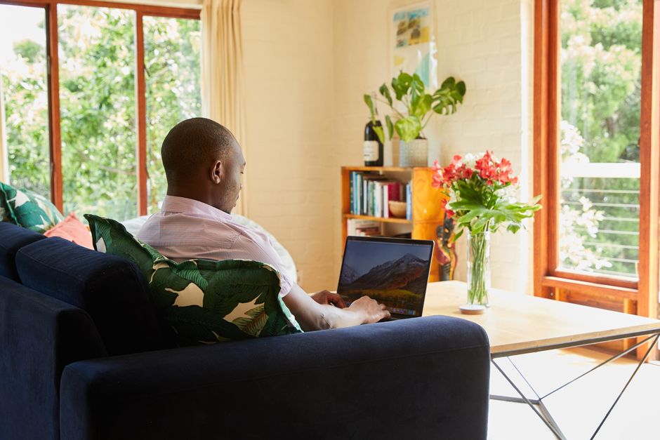 Make money online in Ghana, freelancer working on a laptop with MTN Mobile Money payout