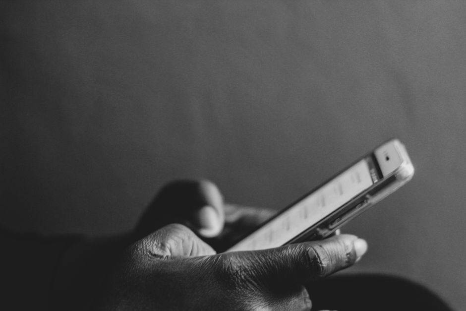 Make money online in Kenya, young person earning from a phone and laptop with M-Pesa payout