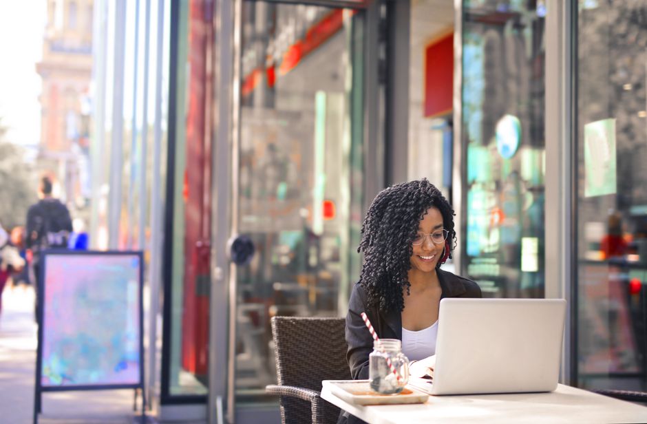 Make money online in South Africa, freelancer working on a laptop, paid via Payoneer to a local bank