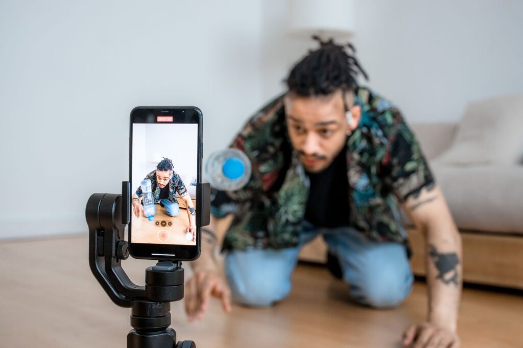 TikTok Spark Ads tutorial creator filming content on phone