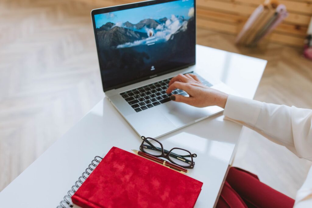 Person working on a laptop with a notebook, illustrating how to start affiliate marketing as a beginner