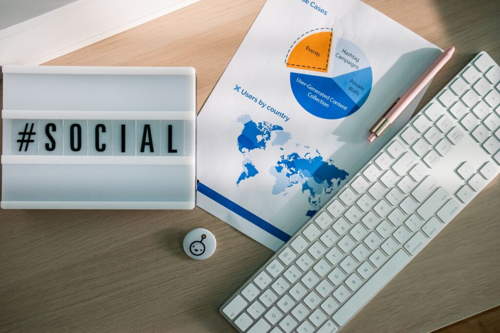 Desk with social media hashtag and analytics charts, illustrating how TikTok Ads Manager campaigns are set up and measured
